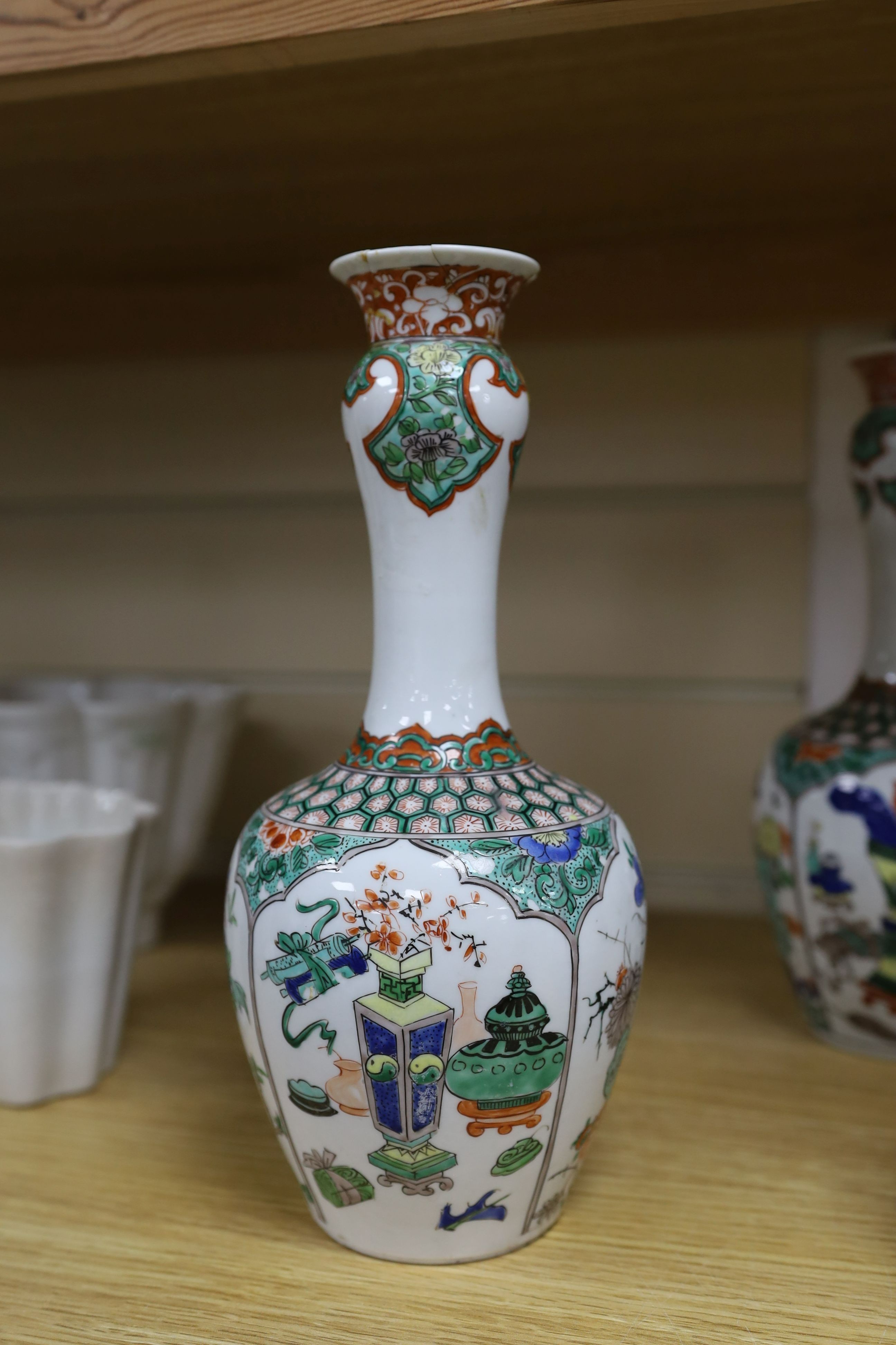 A pair Samson of Paris vases in the Chinese famille verte style and a Chinese Qianlong famille rose garlic neck vase with blue panelling motif, tallest 26cm
